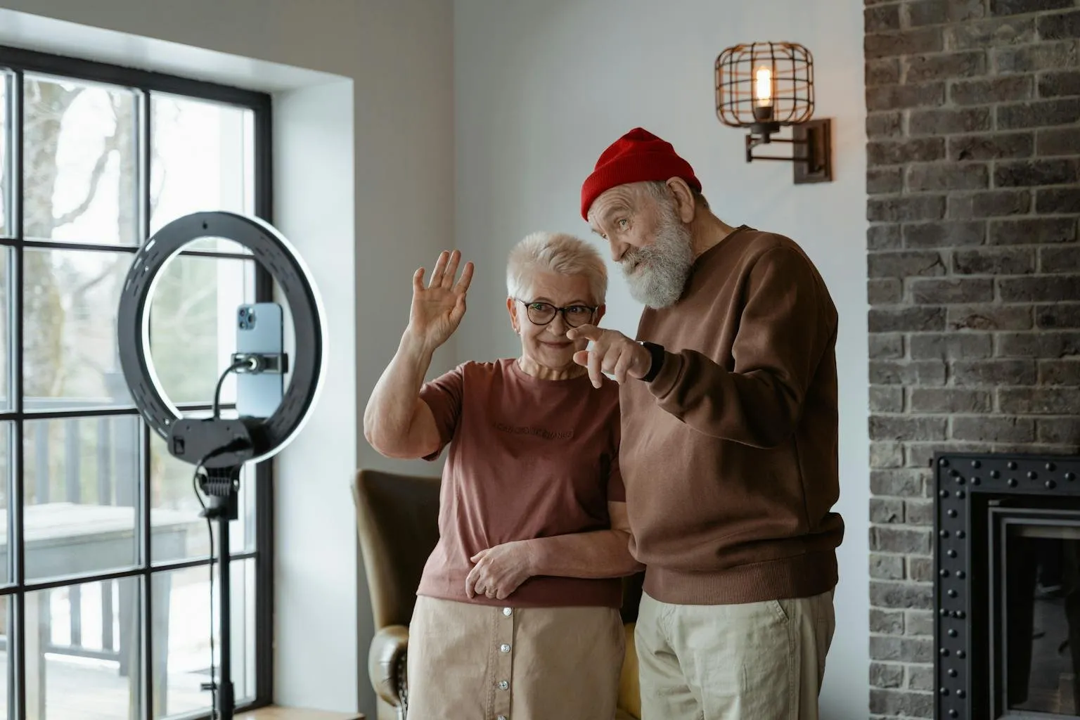 Happy senior couple engaging with technology at home, capturing memories.